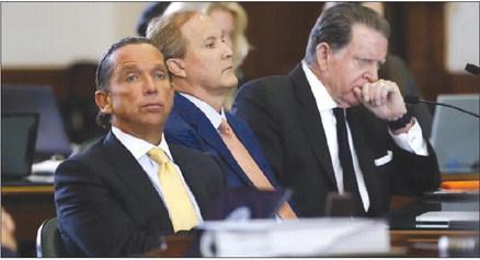 Suspended Attorney General Ken Paxton, center, sits with his lawyers Tony Buzbee, left, and Dan Cogdell at the beginning of the first day of his impeachment trial in the Texas Senate on Sept. 5. Juan Figueroa/Pool via The Dallas Morning News