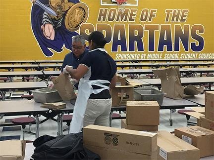 Vanguard Academy Superintendent Dr. Narciso Garcia helps prepare meals for students. In 14 days, nutrition professionals prepared and distributed more than 100,000 meals.