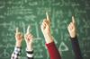 Above: Students raise their hand in a classroom. Below: The Texas Education Agency logo is seen. (Source: TEA) Adobe Stock